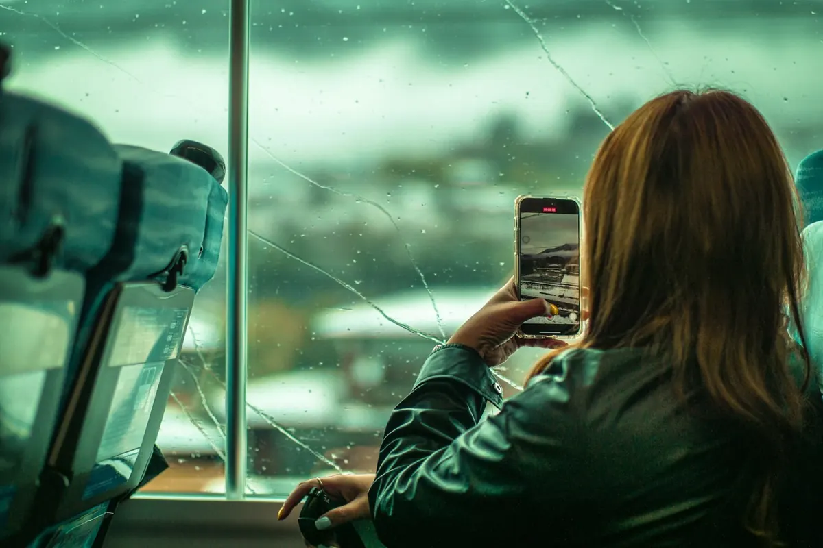A person taking a photo with a phone to document a scene