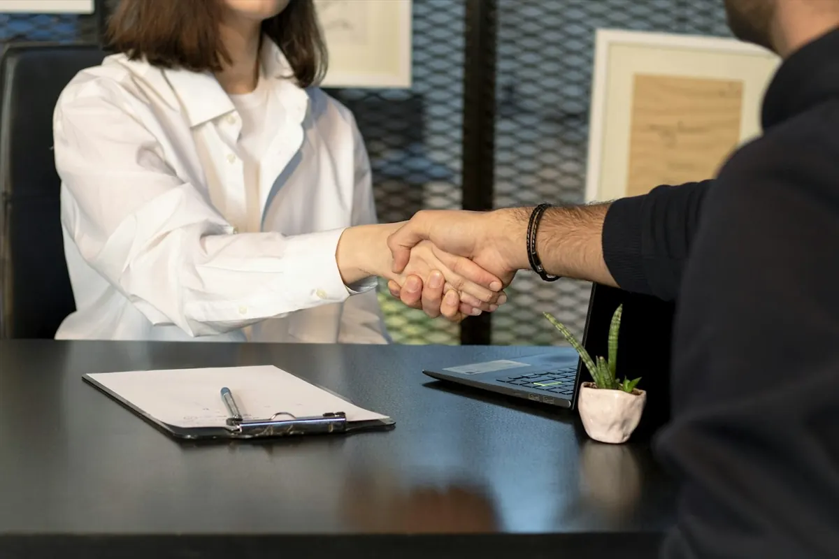 A handshake across a desk after a meeting